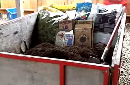 Pour 2 bags of Roots Organic soil into container